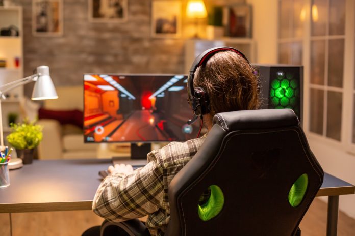 back-view-gamer-male-playing-shooter-his-powerful-pc-computer-late-night-living-room