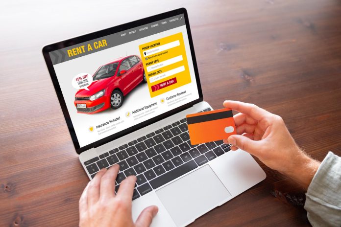 man-renting-car-on-car-rental-website